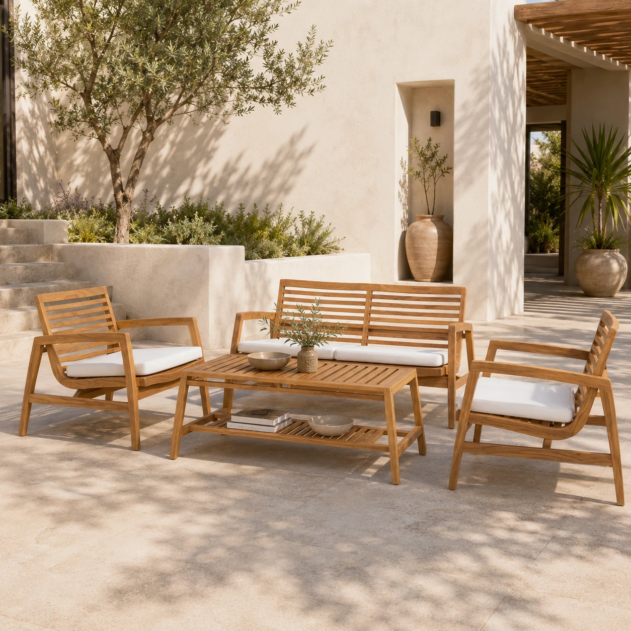 Two-seater teak garden bench on a stone terrace with summer planting behind it