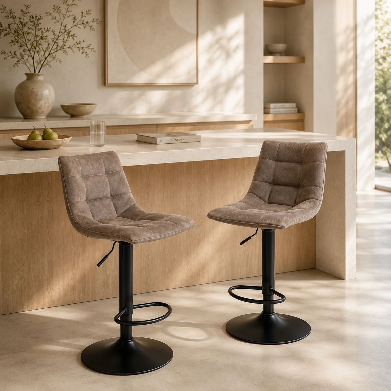Two counter stools with padded backrests at a light breakfast bar in a modern kitchen